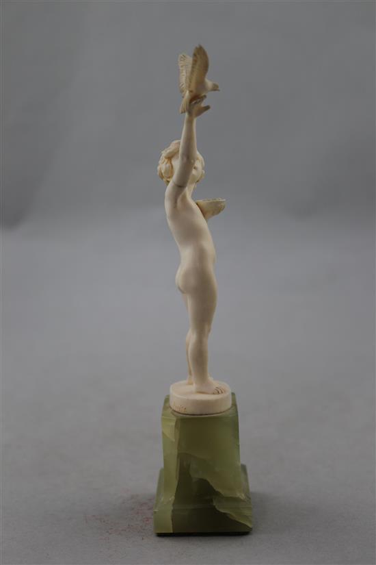 Ferdinand Preiss (German, 1882-1943). An Art Deco carved ivory figure of a young girl feeding a bird, 7.5in.